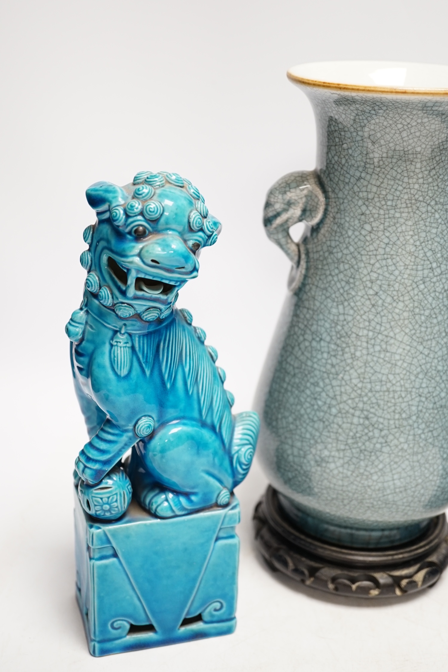 A pair of early 20th century Chinese turquoise glazed dogs of fo and a crackle glazed vase on stand, tallest 29cm. Condition - good, vase has drill hole to base